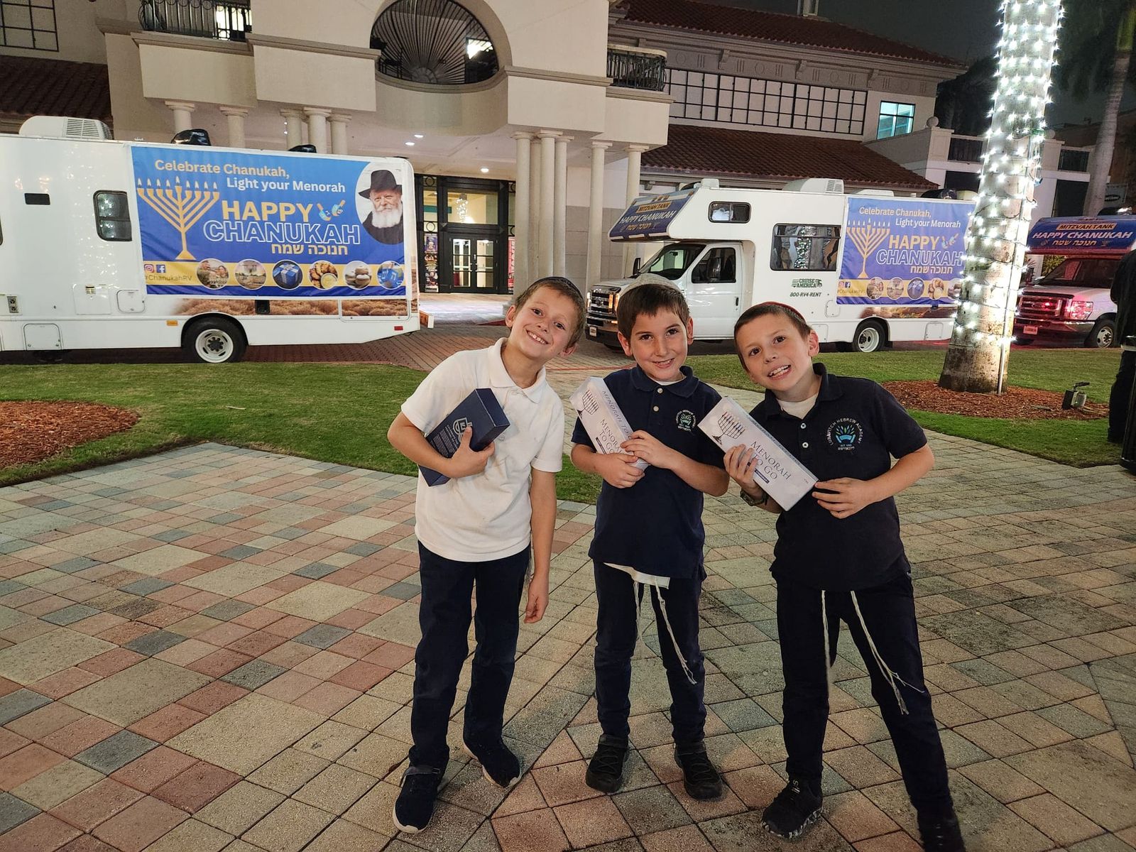 Volunteers handing out menorahs at night