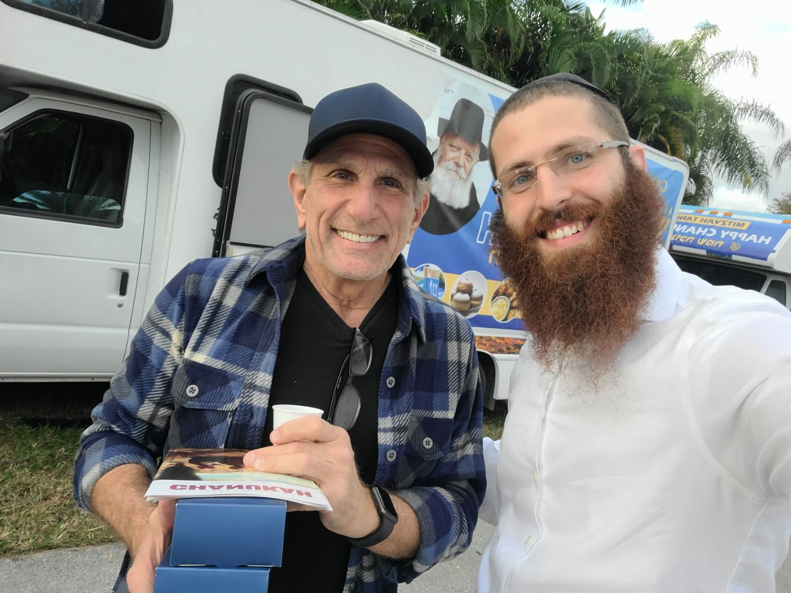 Volunteers presenting a menorah gift at a Mitzvah Tank